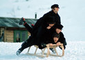 The Beatles, (top to bottom) Ringo Starr, George Harrison (1943-2001), John Lennon (1940-1980) and Paul McCartney, all piled on top of a sledge in the snow during the making of their second feature film Help! in March 1965 in Obertauern, Austria