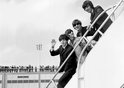 Fans line the rooftop at Kennedy International Airport for a last glimpse of the Beatles -- (left to right) Paul McCartney, Ringo Starr, John Lennon, and George Harrison -- as they fly home to England after their second American tour of the year