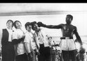 During a visit to the training room of the boxer in Miami, The Beatles were acting as they were knocked out by the American boxer Muhammad Ali