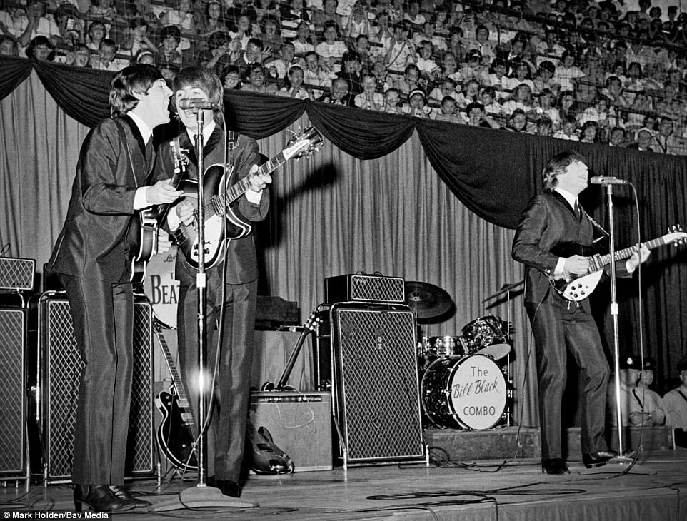 These never-before-seen pictures of iconic musicians and bands including The Beatles are set to go on display in the UK this summer. Pictured, The Beatles performing at Maple Leaf Gardens in Ontario, Canada, in 1964